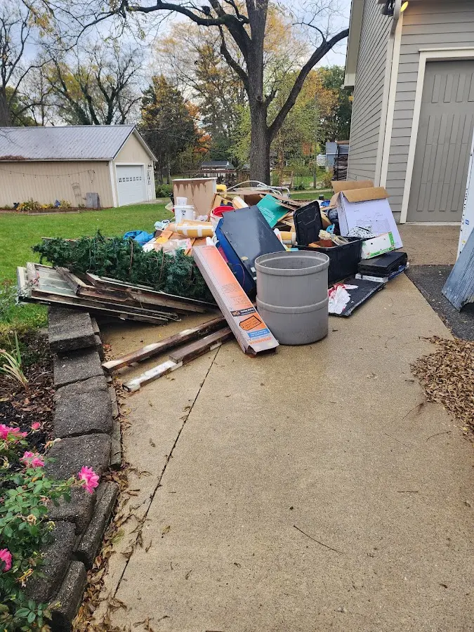 Dumpster being loaded with debris for 3 Yard Dumpster Rental in East Moline